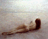Nude woman contemplating a distant horizon
